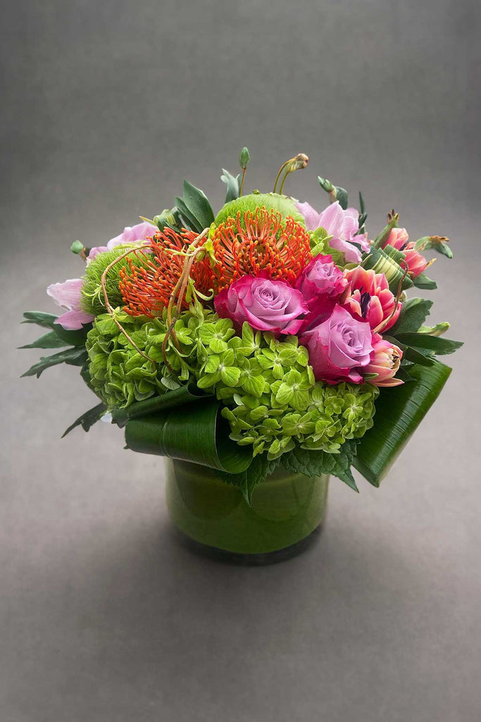 Mixed colorful arrangement in a round vase