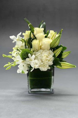 Arrangement of white flowers with roses, lilies, orchids and hydrangeas 