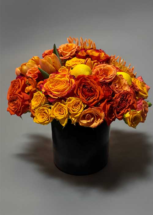 Orange flowers in a black vase