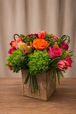 Wooden Charm floral arrangement in a rustic wooden box with green hydrangea, roses, tulips, cymbidium orchids, berry accents, and seasonal blooms.