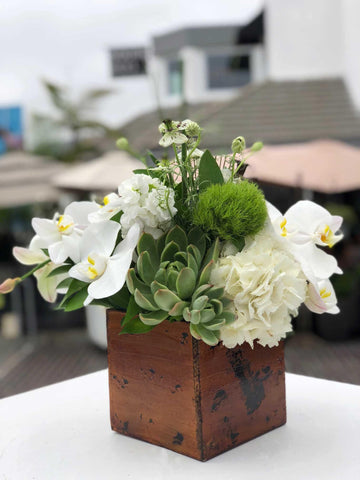 White and green beachy  arrangement in a wooden box